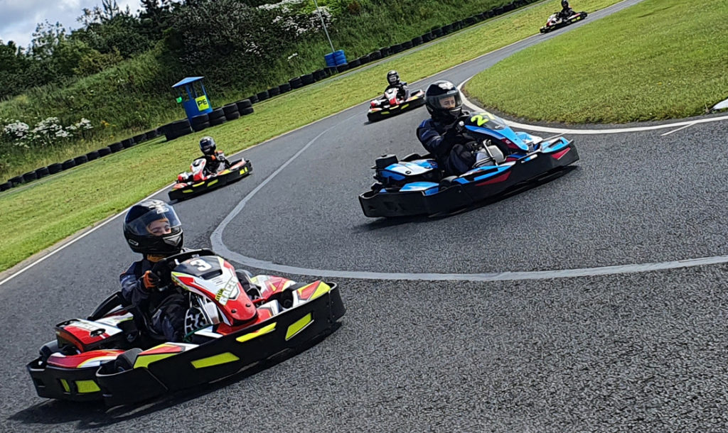 Family Karting with adults and children on outdoor circuit